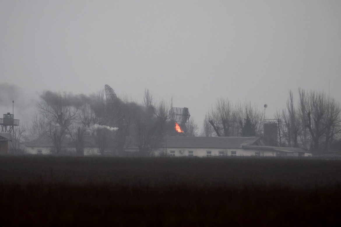 Fire is seen coming out of a military installation near the airpor