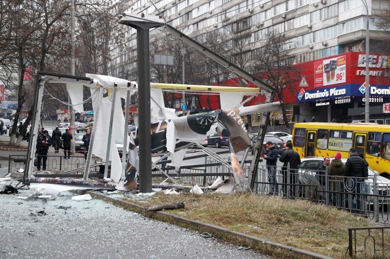Debris and rubble are seen at the site where a missile landed in the street in Kyiv, Ukraine