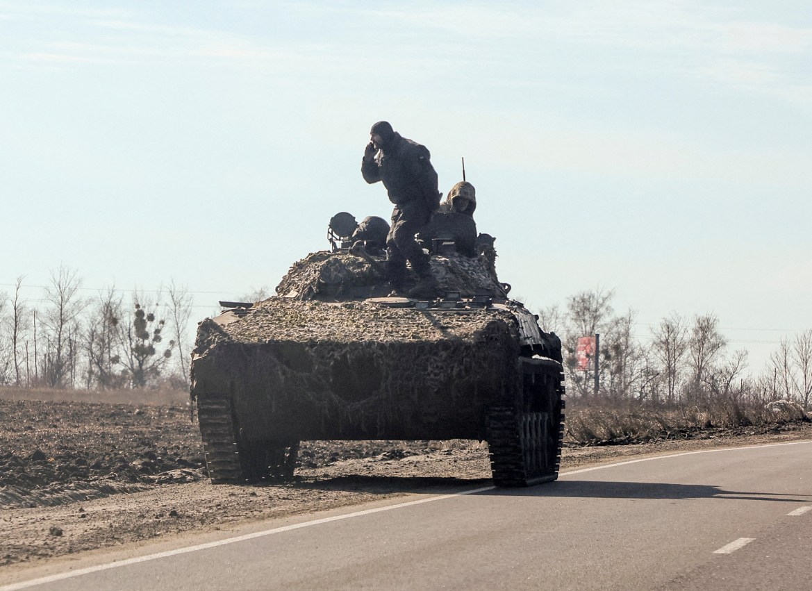 Ukrainian army soldiers are seen on an armoured vehicle