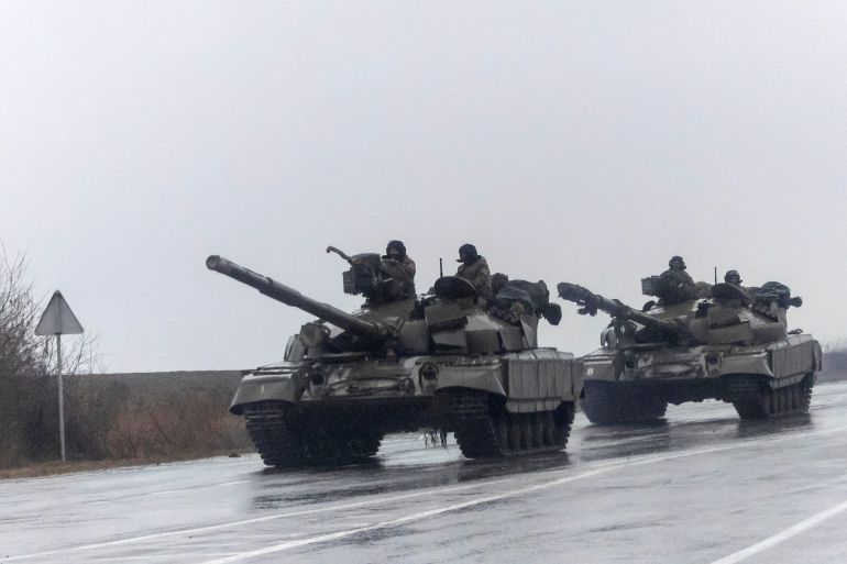 Ukrainian tanks move into the city after Russian President Vladimir Putin authorized a military operation in eastern Ukraine, in Mariupol [Carlos Barria/Reuters]
