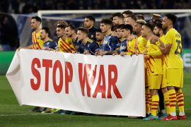 Napoli and Barcelona players display a 'Stop War' banner