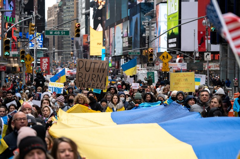 Protesters carrying large Ukrainian flag