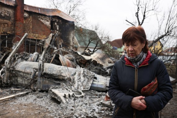 A person in Kyiv walks around the wreckage of an unidentified aircraft that crashed into a house in a residential area