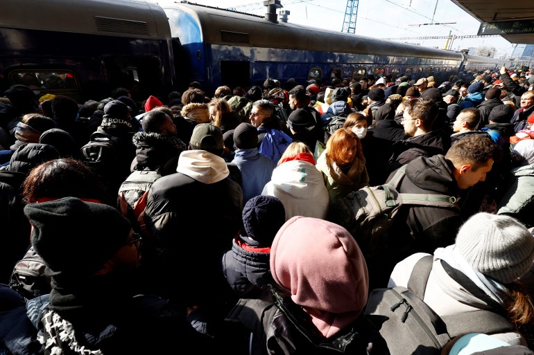 People wait to board an evacuation train from Kyiv to Lviv