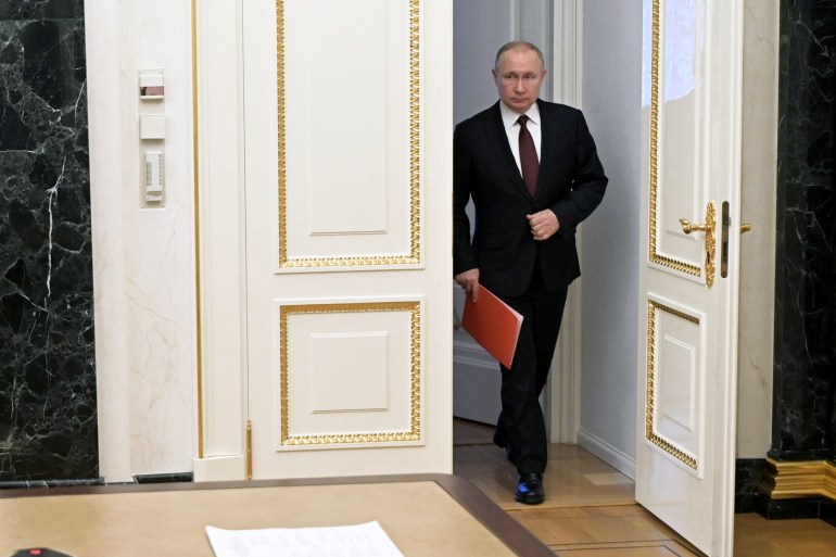 Russian President Vladimir Putin enters a hall before a meeting with members of the Security Council via a video link in Moscow, Russia February 25, 2022. Sputnik/Alexey Nikolsky/Kremlin via REUTERS ATTENTION EDITORS - THIS IMAGE WAS PROVIDED BY A THIRD PARTY.