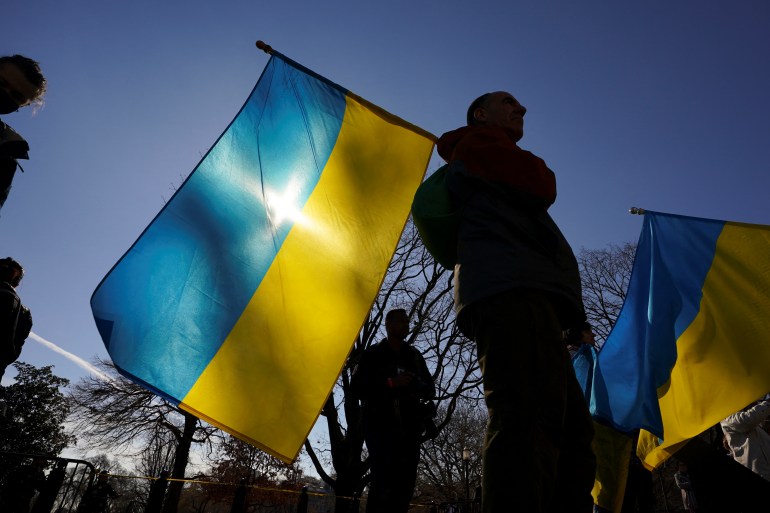 A man holds a Ukraine flag during a demonstration in front of the White House to support Ukraine and protest Russia's invasion of the country, in Washington, U.S.,
