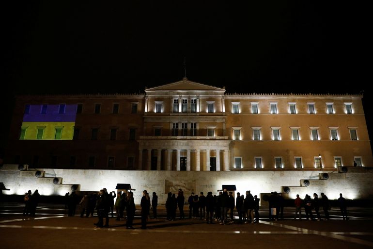 The colours of the Ukrainian flag are projected on the facade of the parliament building in support of the Ukrainian people after Russia launched a massive military operation against Ukraine, in Athens, Greece, February 26, 2022.