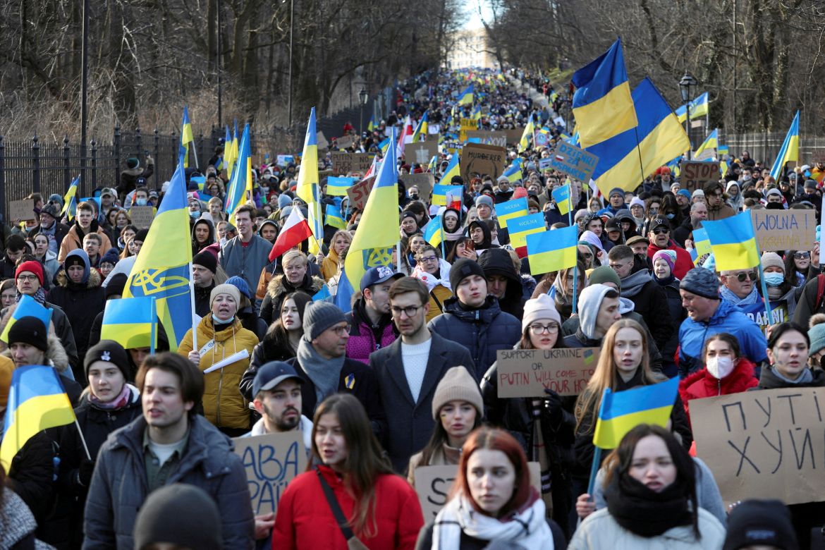 People march during an anti-war protest, after Russia launched a massive military operation against Ukraine, in Warsaw