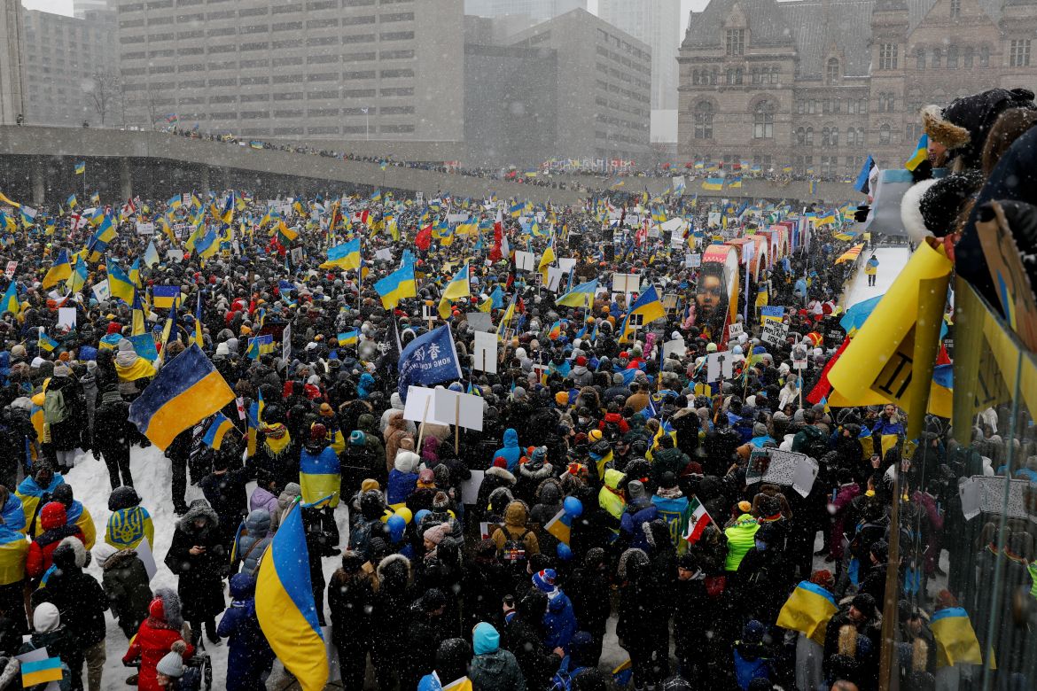 People take part in an anti-war protest, after Russia launched a massive military operation against Ukraine, in Toronto