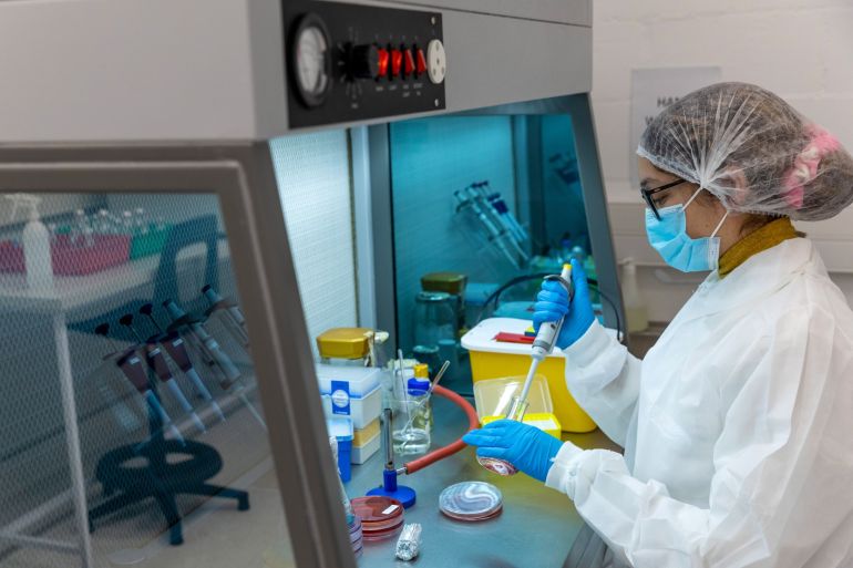 A technician uses a single channel pipette dropper inside the Afrigen Biologics &amp; Vaccines Ltd. laboratory facility in Cape Town