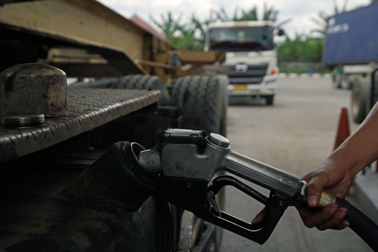 Person filling up petrol in Indonesia