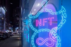 An illuminated neon sign of an NFT displayed in Hong Kong
