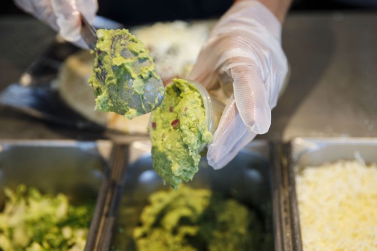 An employee scoops guacamole at a Chipotle Mexican Grill Inc. restaurant in El Segundo, California, USA