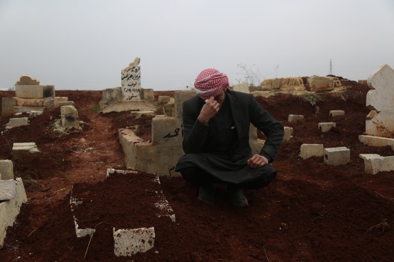 Fatima’s father Mohamad Al Hassan sits by her grave near Laith displacement camp where they lived for seven years