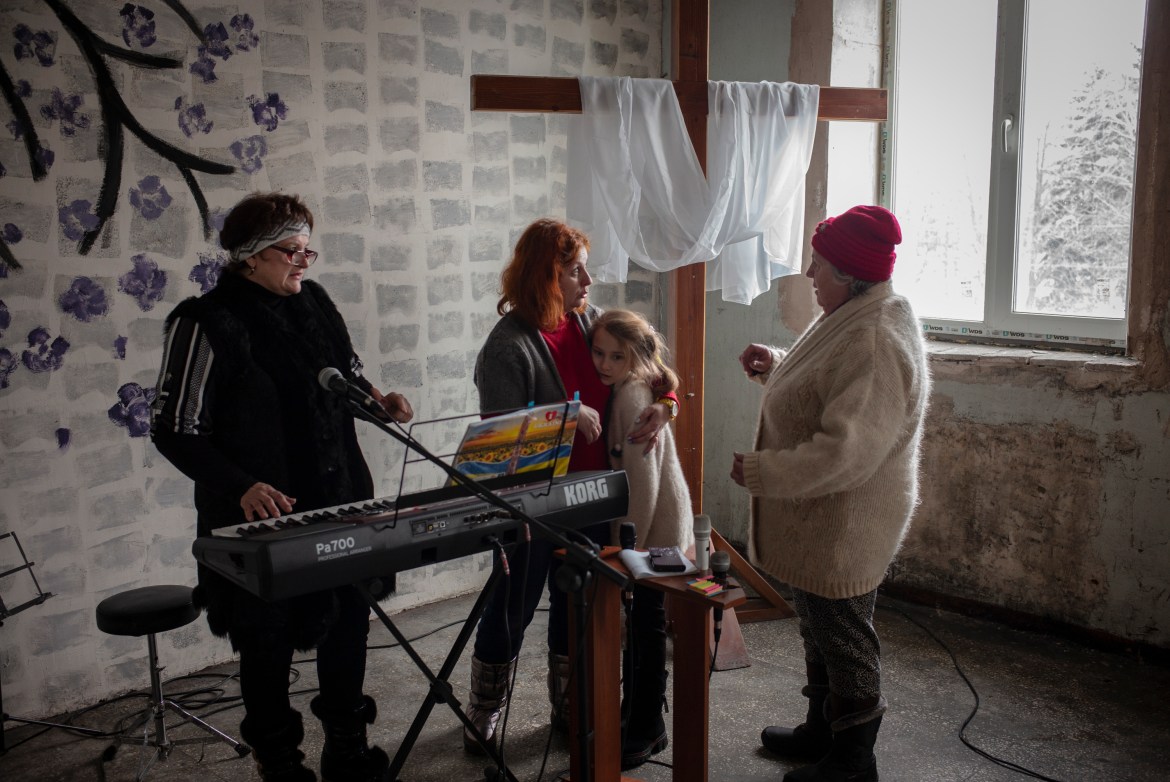 Maria, 56 (on the right), joins her Protestant church every Sunday in the front line village of Marinka