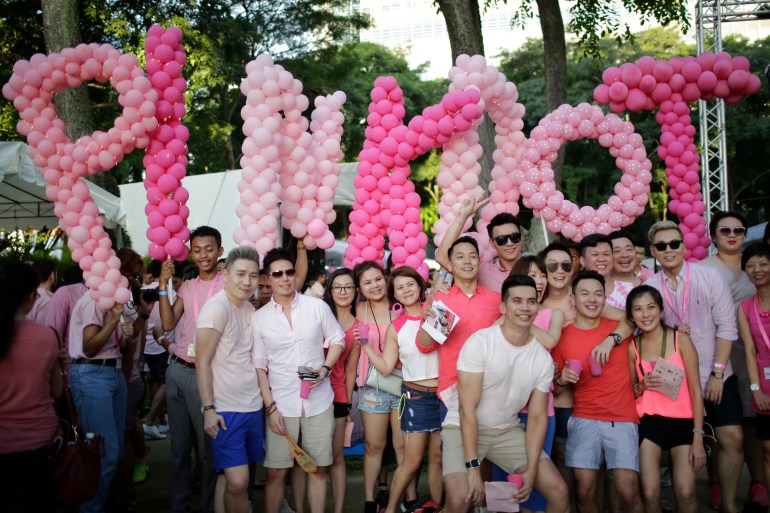 People gather at Hong Lim Park in Singapore with balloons spelling out 'Pin, Dot' the name of the event