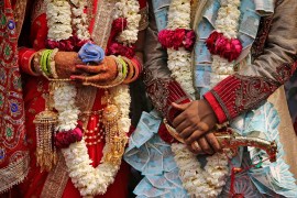 A newly wed Indian couple poses for photographs during a mass marriage ceremony for eight couples in New Delhi