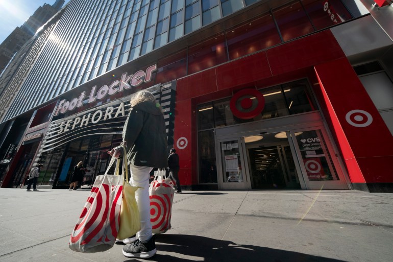 A woman carries Target shopping bags as she leaves the store,