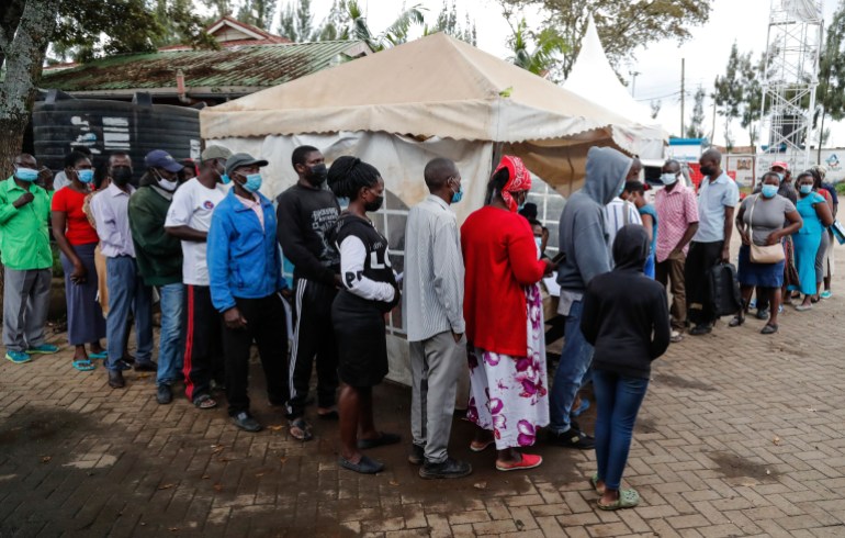 Kenyans queue at vaccination centers at the Kibera informal settlement in Nairobi