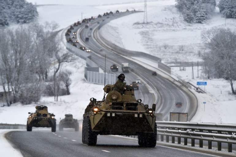 A convoy of Russian armored vehicles moves along a highway in Crimea, Jan. 18, 2022. Amid a buildup of Russian troops near Ukraine, Moscow has denied planning an attack on Ukraine but urged the U.S. and its allies to provide a binding pledge that NATO won't expand to Ukraine and won't deploy military assets there _ a demand rejected by the West.