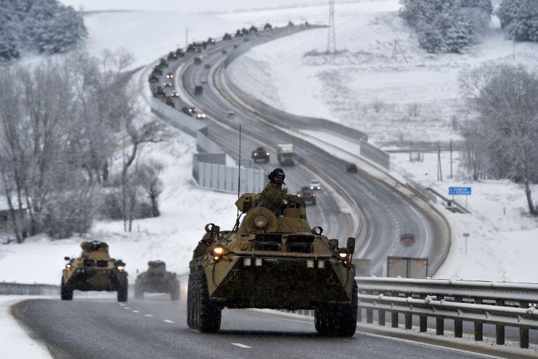 A convoy of Russian armored vehicles moves along a highway in Crimea, Jan. 18, 2022. Amid a buildup of Russian troops near Ukraine, Moscow has denied planning an attack on Ukraine but urged the U.S. and its allies to provide a binding pledge that NATO won't expand to Ukraine and won't deploy military assets there _ a demand rejected by the West.