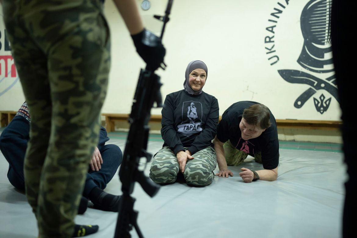 Svetlana Putilina smiles as she listens to an instructor during the training in Kharkiv,