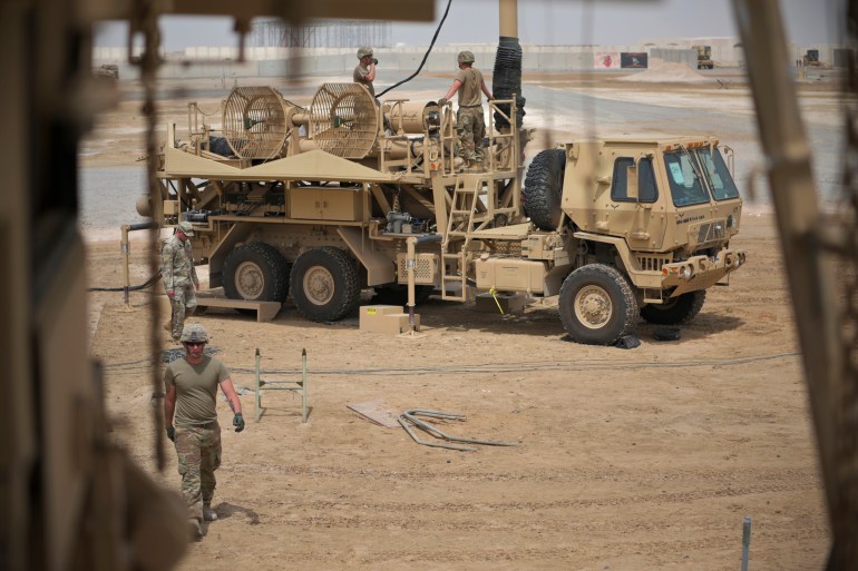 US Army troops work near a Patriot missile battery at Al-Dhafra Air Base in Abu Dhabi, United Arab Emirates.
