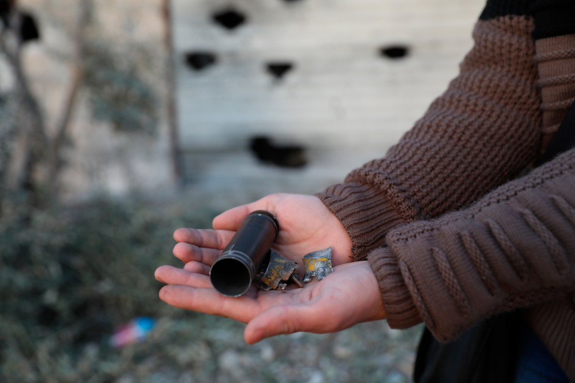 A child shows an empty bullet shell