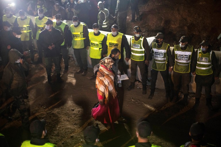 Parents of 5-year-old Rayan walk towards the tunnel as their son's body was being retrieved