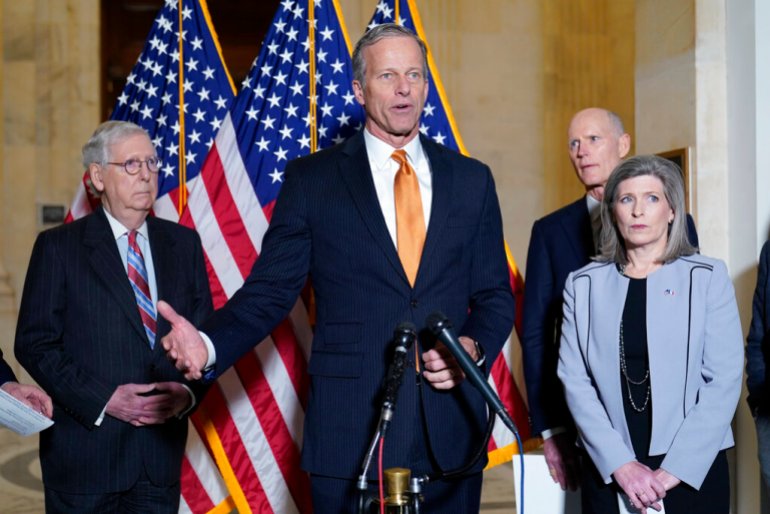 Sen. John Thune, R-S.D., second from left, speaks to reporters on Capitol Hill in Washington, Tuesday, Feb. 8, 2022. Standing with Thune is, from left, Senate Minority Leader Mitch McConnell of Ky., Sen. Rick Scott, R-Fla., and Sen. Joni Ernst, R-Iowa.