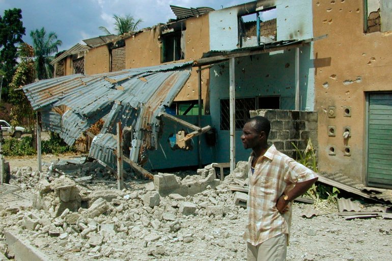 A Congolese man looks at the destruction of the Tshopo neighborhood of Kisangani