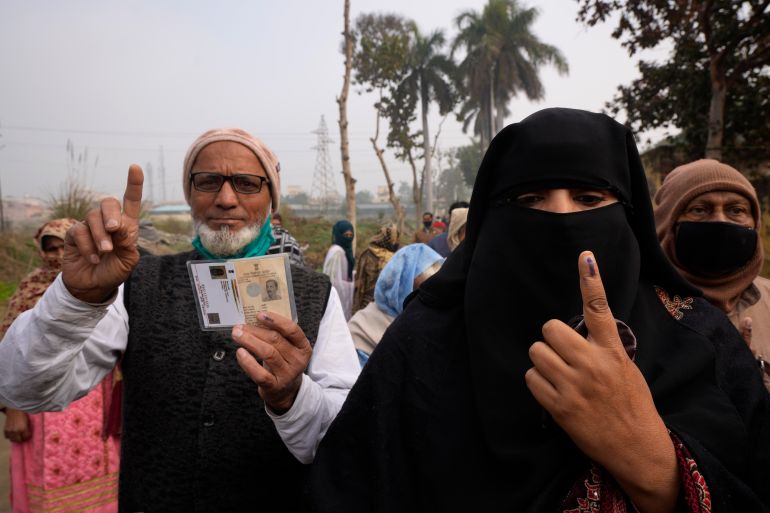 Indian Muslims display their index fingers after casting their votes during the first phase of Uttar Pradesh state elections