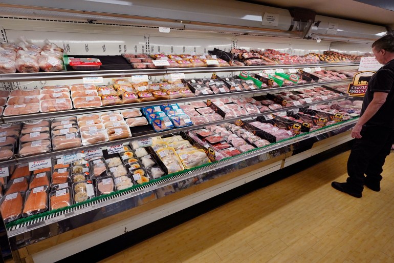 A man looks at beef in the meat department of a supermarket