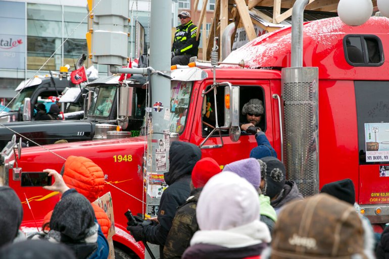A crowd stands next to a truck in Ottawa