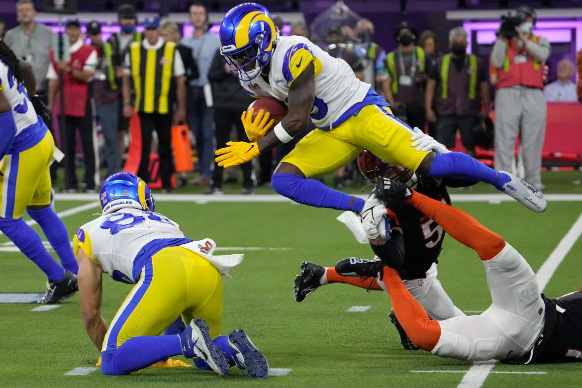 Los Angeles Rams wide receiver Brandon Powell, top, leaps over Cincinnati Bengals defenders during the second half