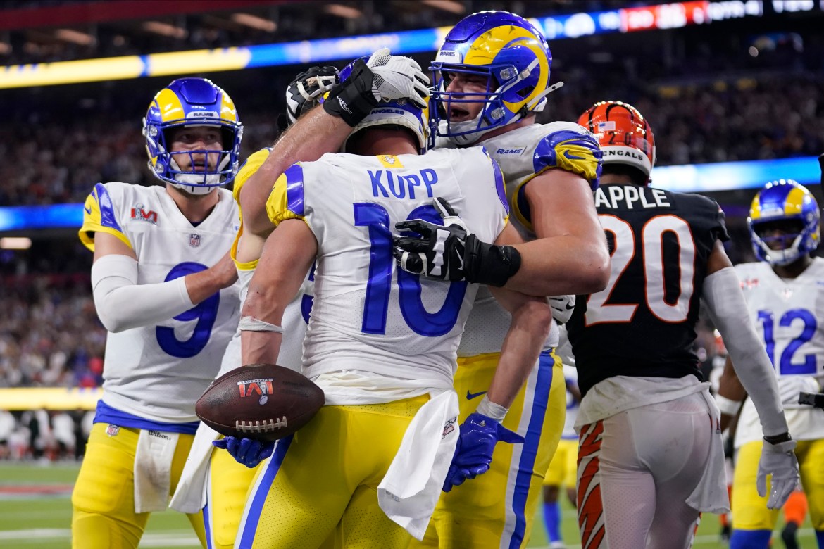 Los Angeles Rams wide receiver Cooper Kupp (10) is congratulated by teammates after scoring a touchdown