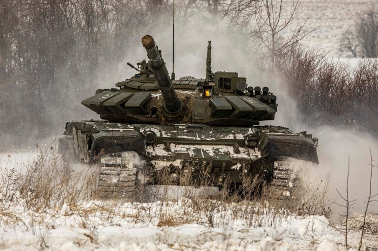 A Russian tank rolls on the field during military drills in Leningrad region, Russia.