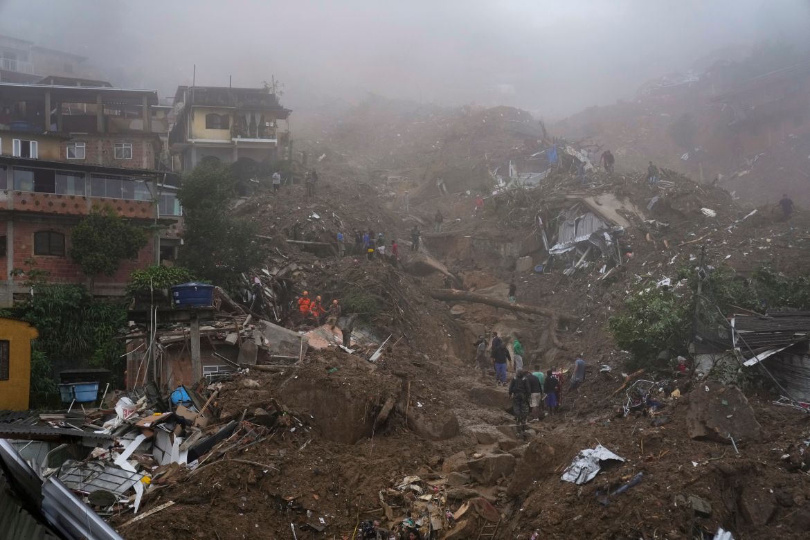 Rescue workers and residents look for victims in an area damaged by landslides in Petropolis