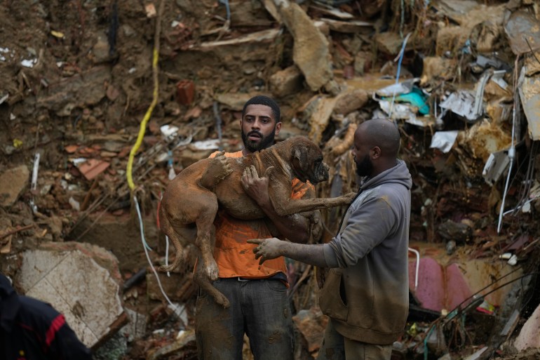 Man carries dog rescued from mudslide