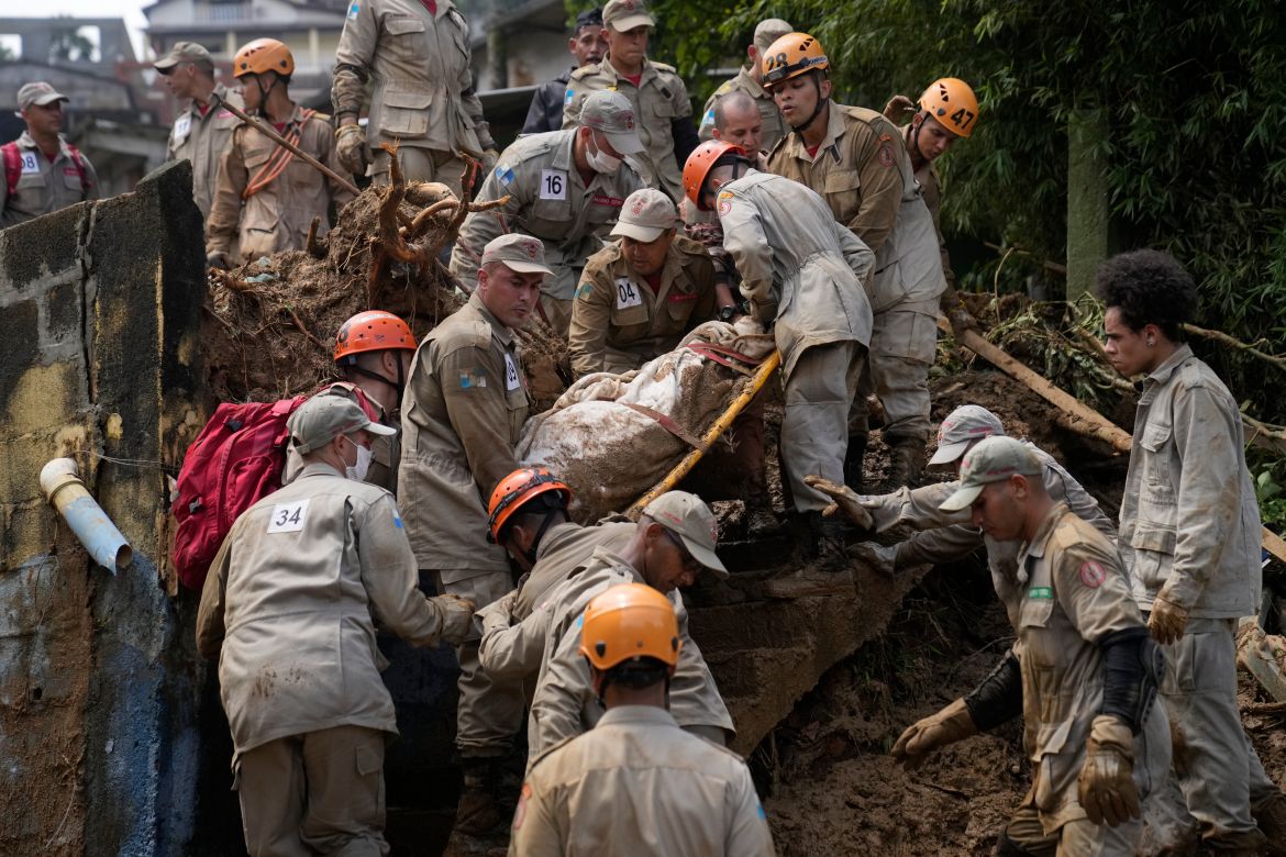 Rescue workers recover the body of a mudslide victim in Petropolis