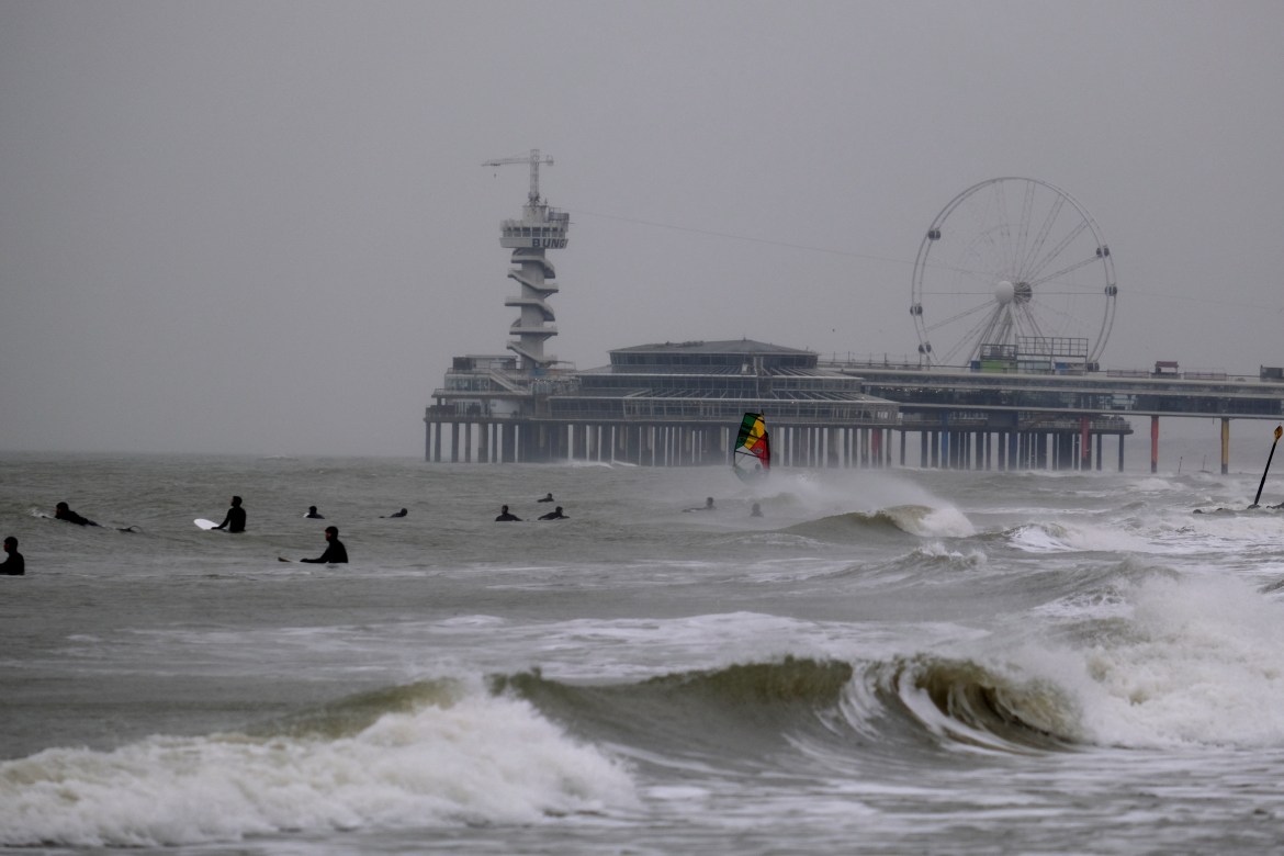 Surfers wait for waves whipped up by storm Eunice at Scheveningen, the Netherlands, on Friday Feb. 18, 2022. The Netherlands and other western European nations were bracing for the second powerful storm in three days. (AP PHOTO/Mike Corder)