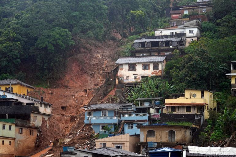 The path of a mudslide marks a hillside full of homes on the third day of rescue efforts in Petropolis, Brazil