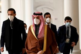 Saudi Arabia's Minister of Foreign Affairs Prince Faisal bin Farhan al-Saud (C) arrives for a meeting