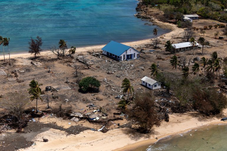 ebris from damaged building and trees are strewn around on Atata Island in Tonga, on Jan. 28, 2022, after a massive volcanic eruption and tsunami