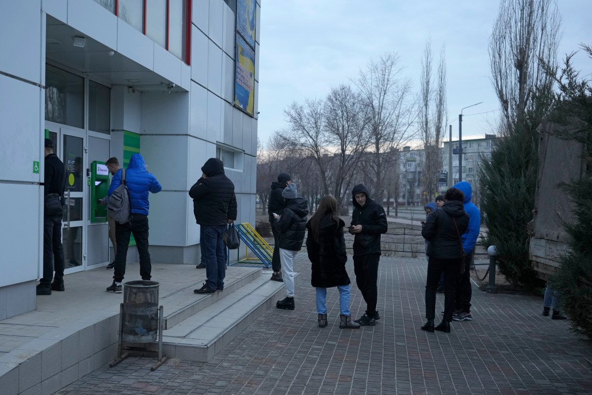 People queue to use an ATM machine outside in Sievierodonetsk