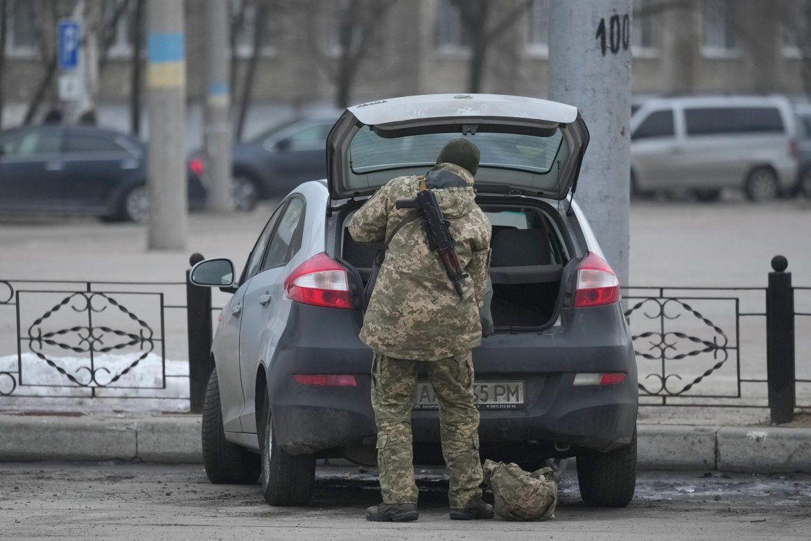 A member of the Ukrainian military takes items from the back of a car in Sievierodonetsk,