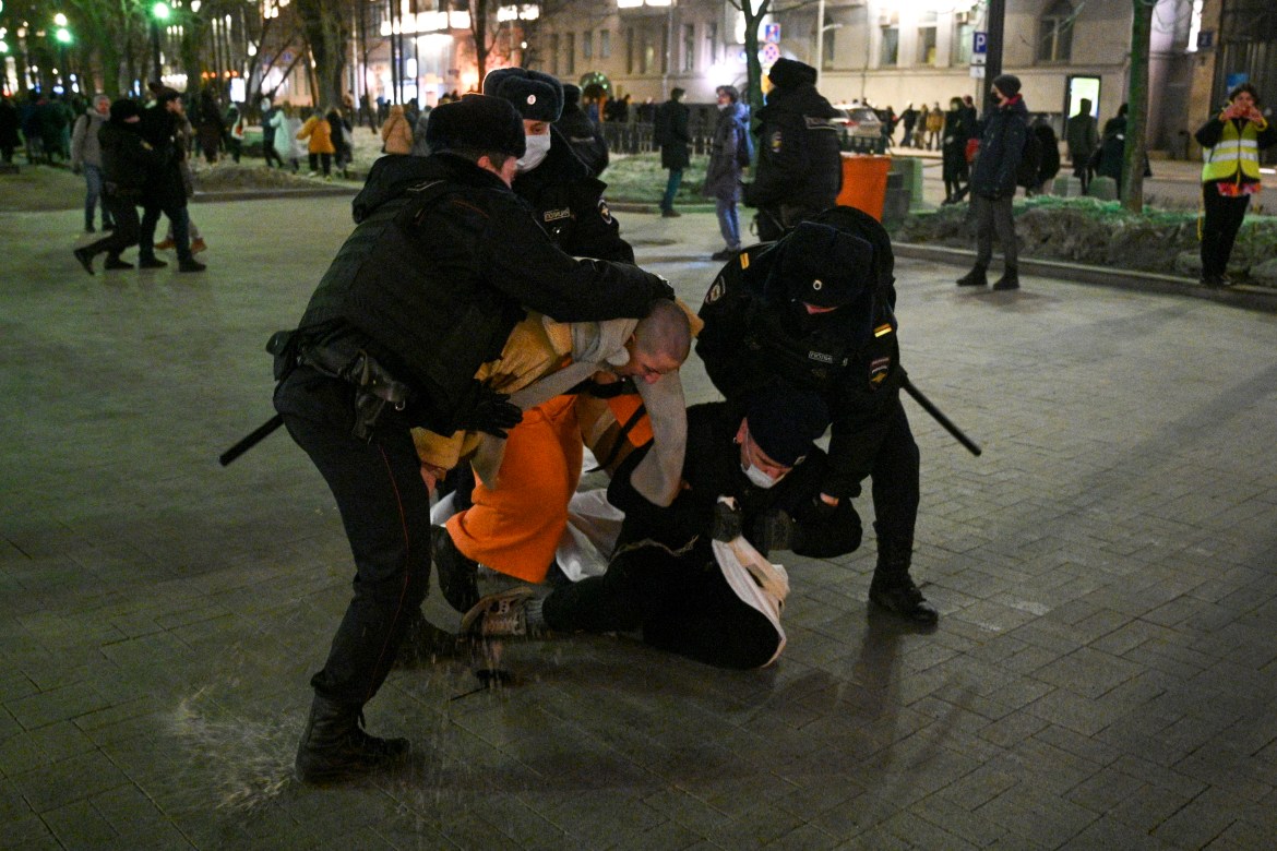 Police officers detain demonstrators in Moscow