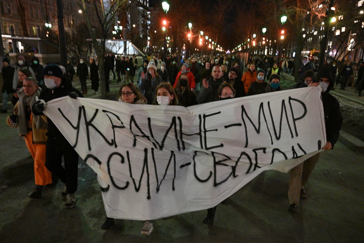 Demonstrators march with a banner that reads: "Ukraine - Peace, Russia - Freedom", in Moscow