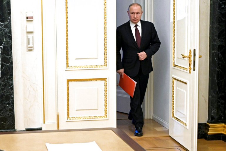 Vladimir Putin walking into a room.