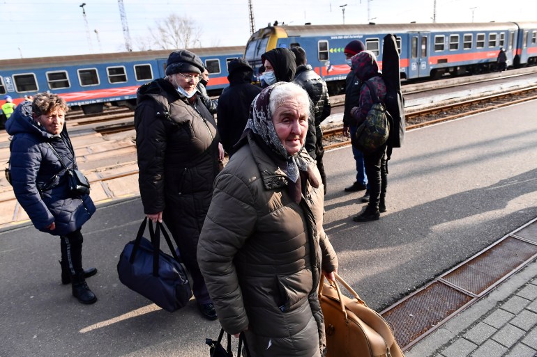 Ukrainian refugees are seen arriving at a train station in Hungary
